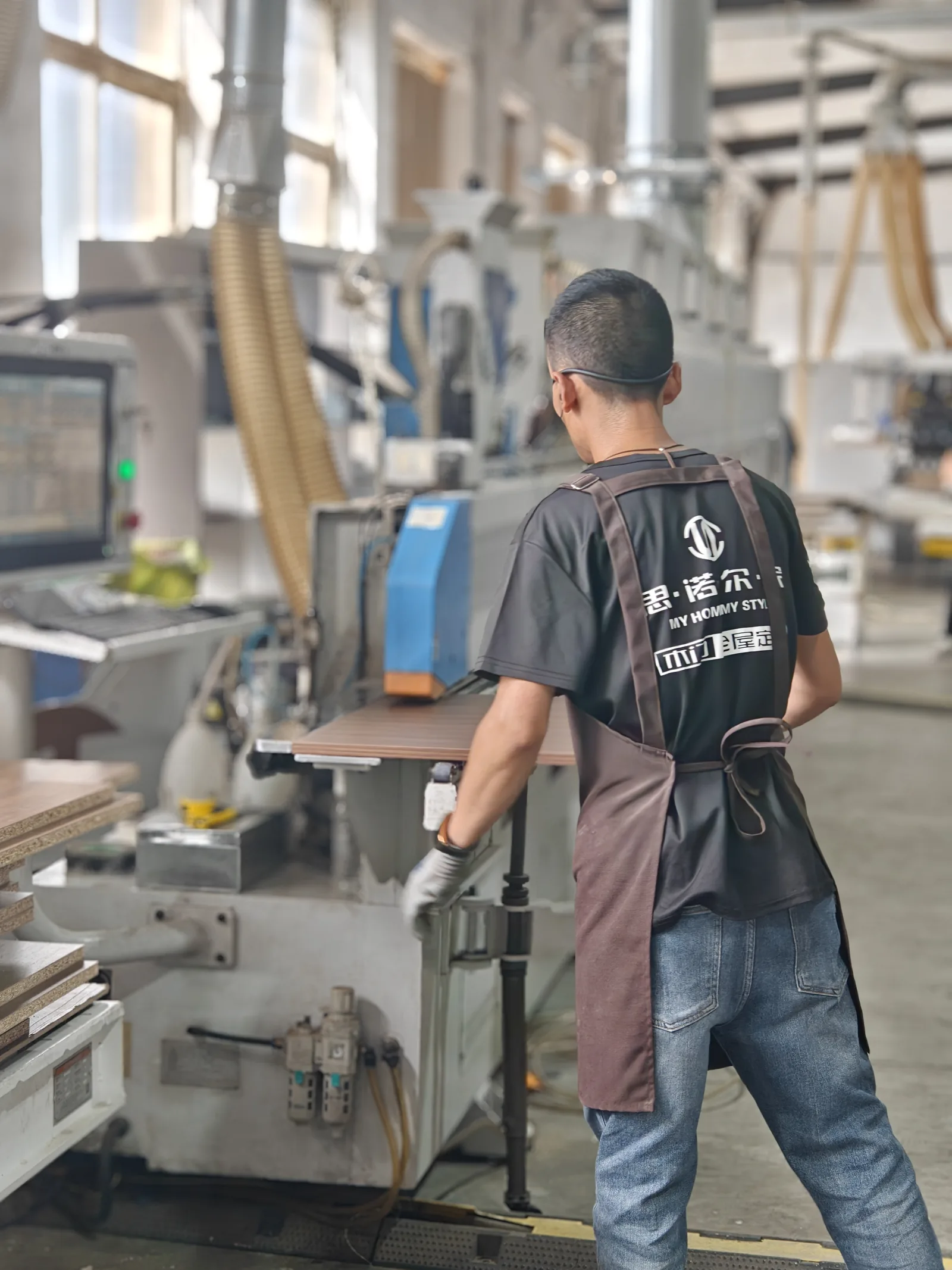 SNEJ operator processing panels on production machinery