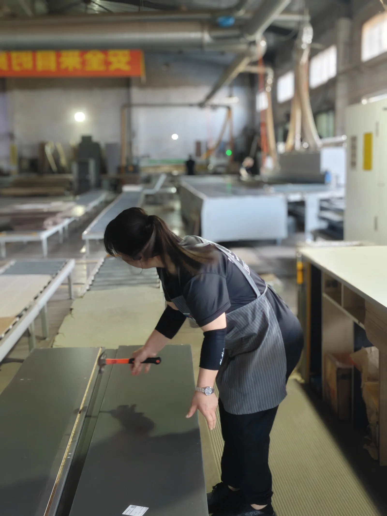 SNEJ team member measuring a panel during production