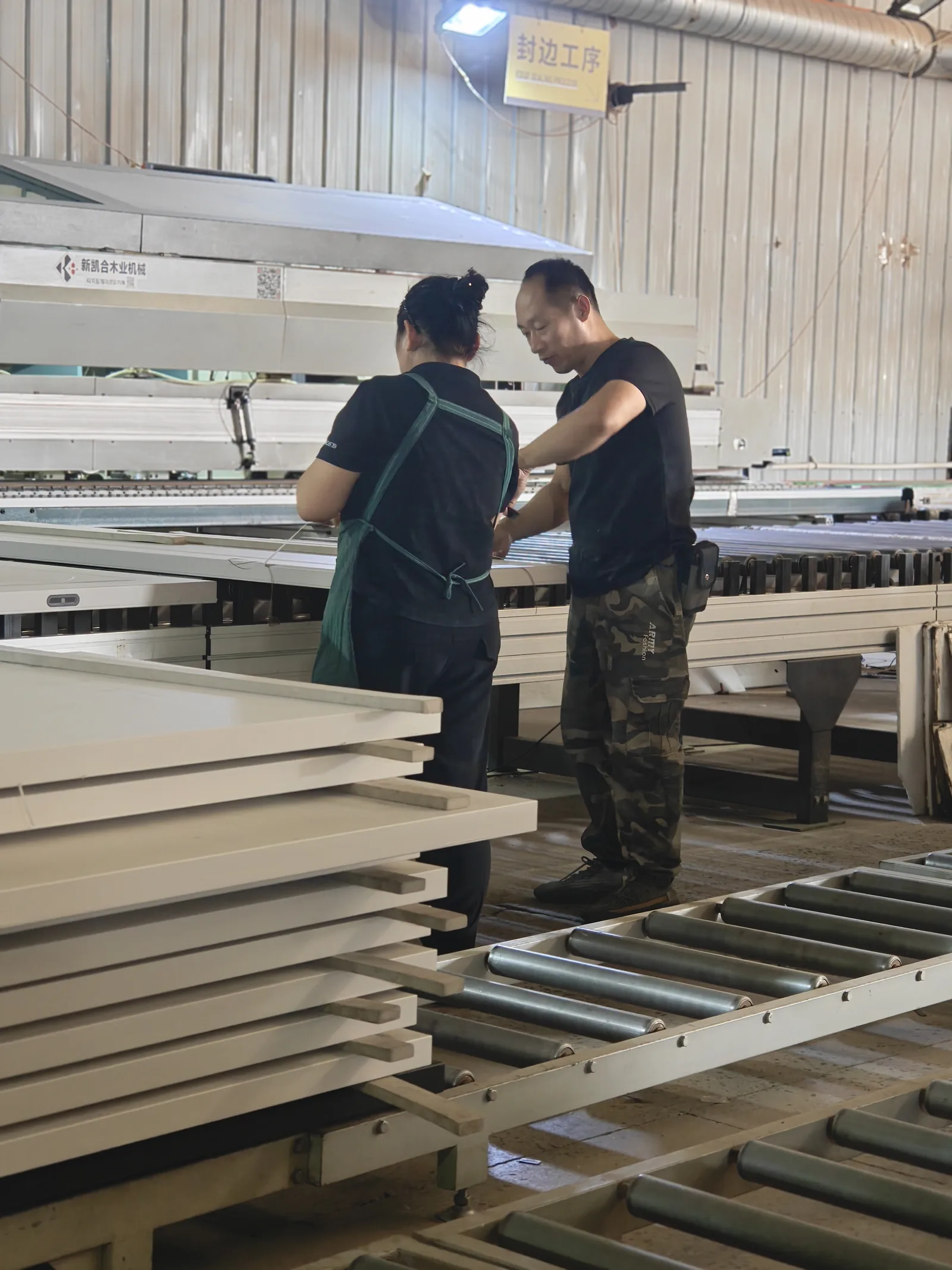 SNEJ operators checking components at an automated panel processing line